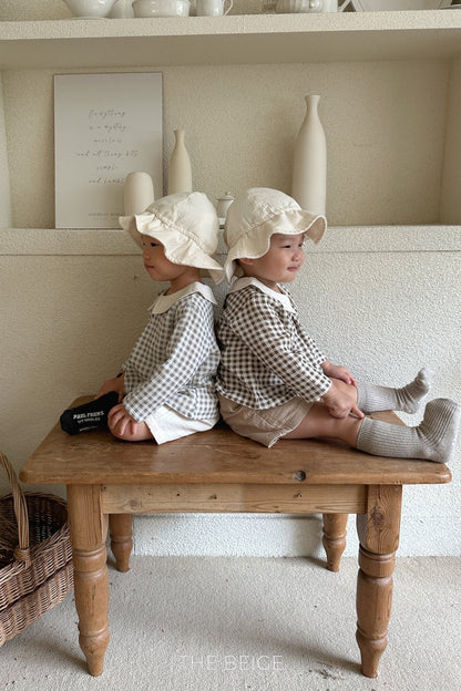 the beige mandu bucket hat