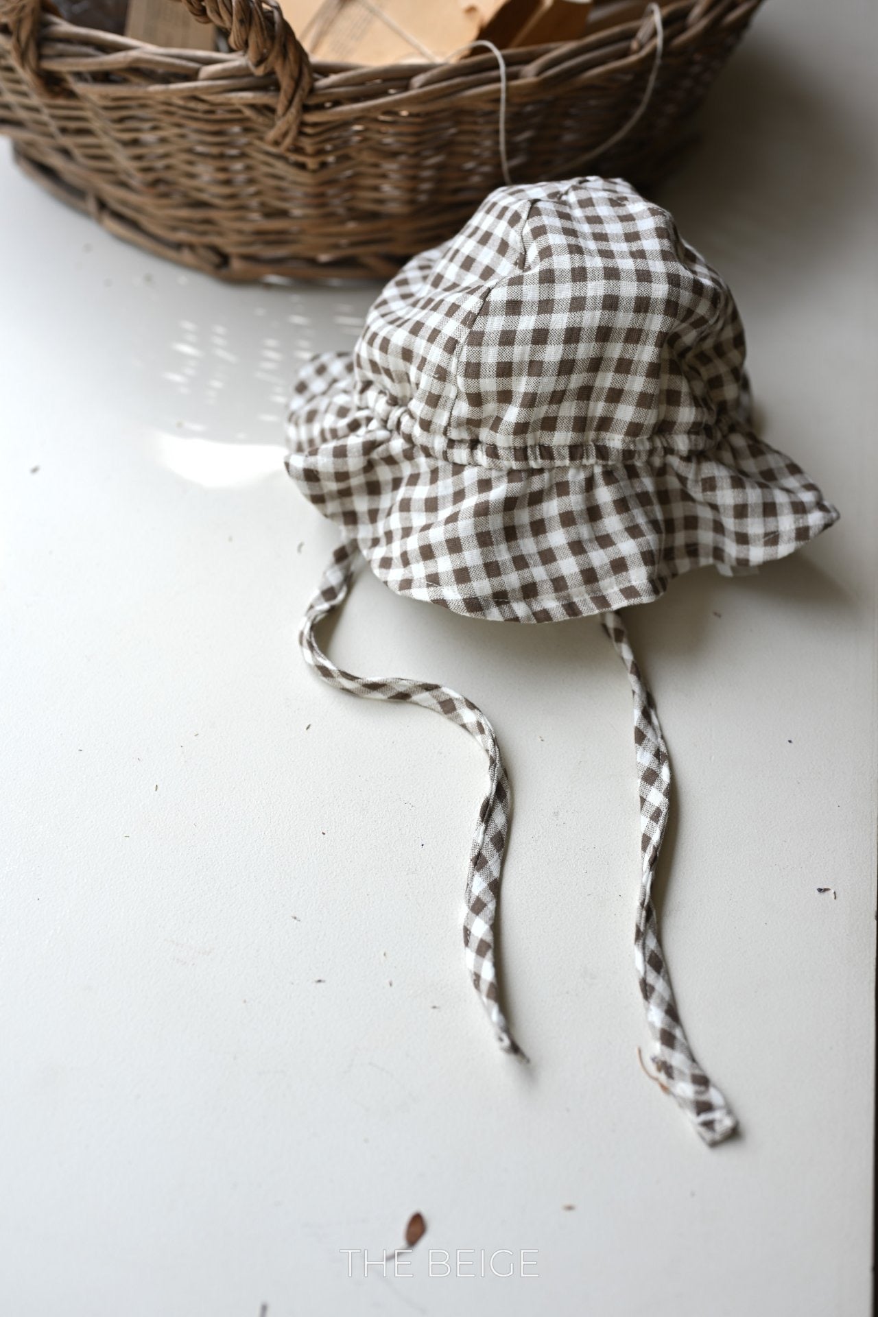 the beige mandu bucket hat