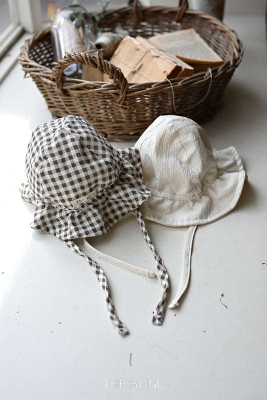 the beige mandu bucket hat